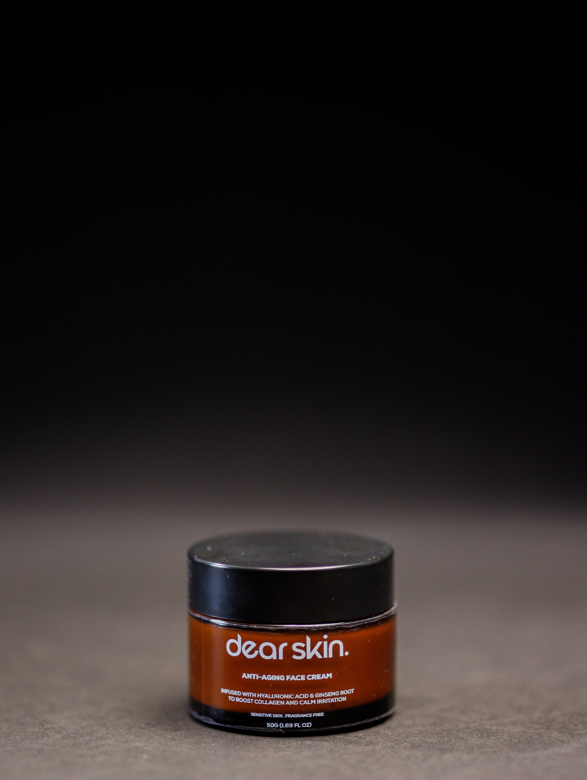 Dear Skin Anti-aging Face Cream in a sleek jar, enriched with ginseng root and hyaluronic acid for firm, radiant skin.