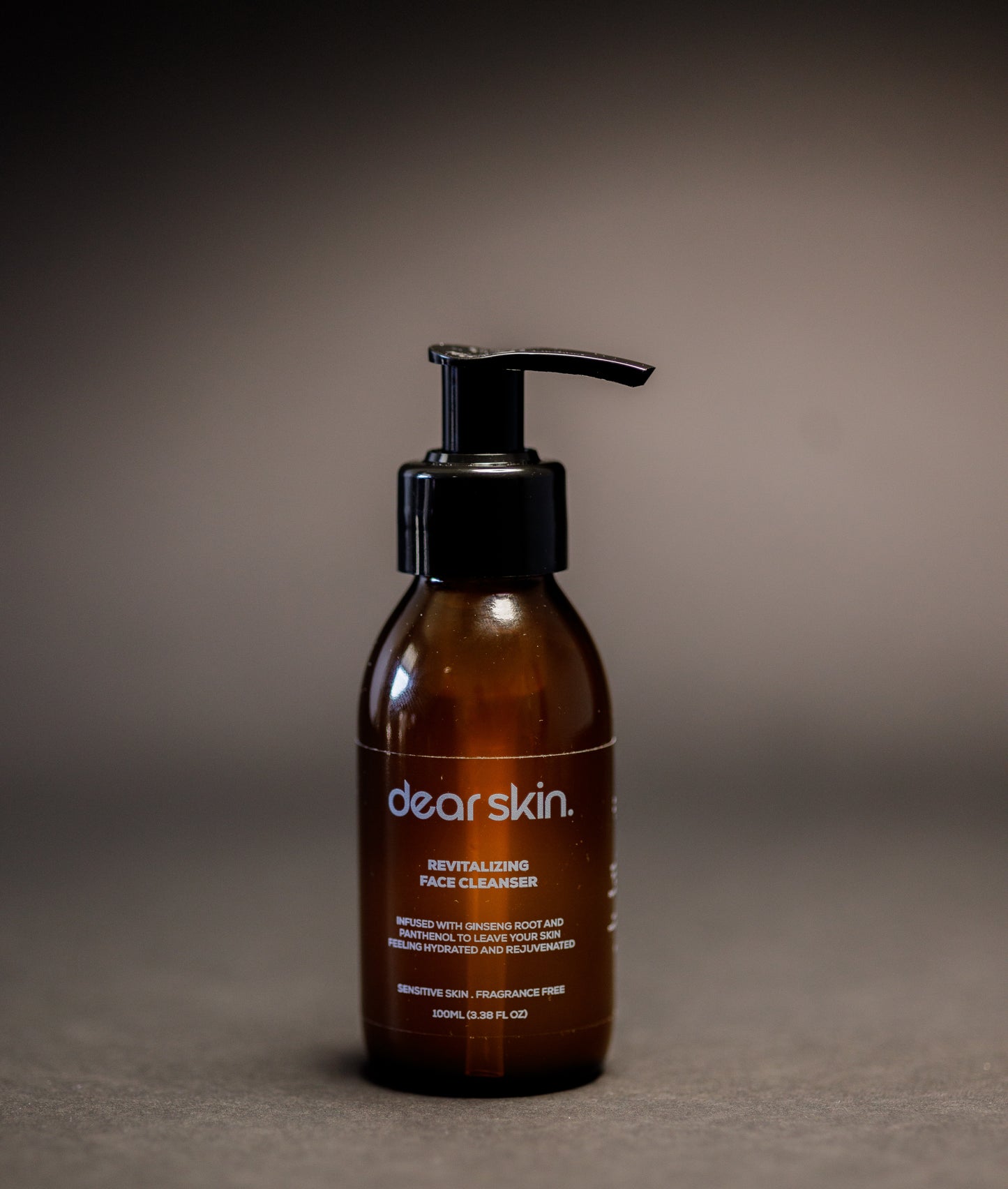 Dear Skin Revitalizing Face Cleanser in a 100ml amber bottle, featuring a gentle formula with ginseng root and D-Panthenol for refreshed, balanced skin