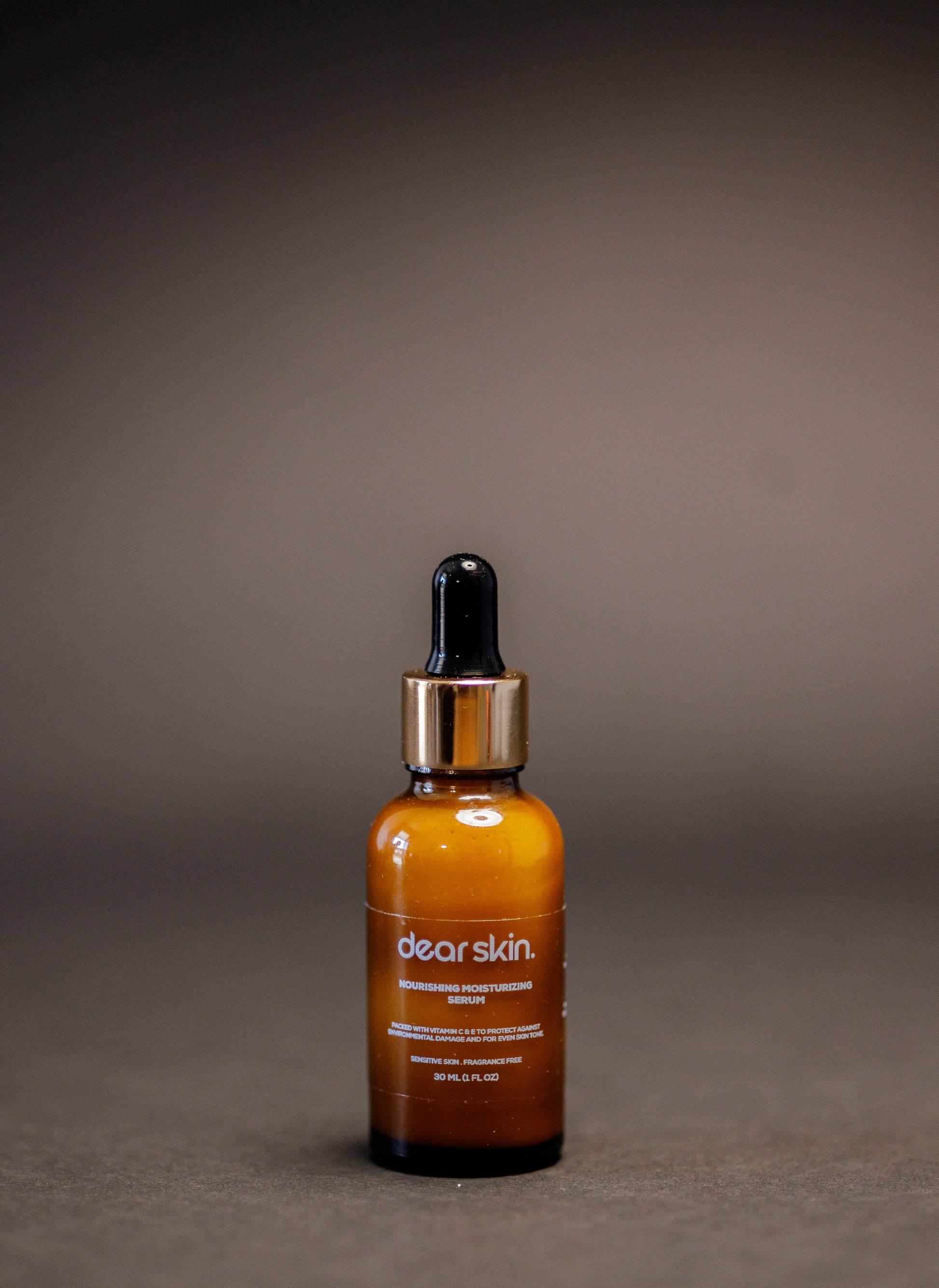 Dear Skin Nourishing Moisturizing Serum in a 30ml amber glass bottle, powered by Vitamin C, aloe vera, and baobab oil for radiant, hydrated skin.
