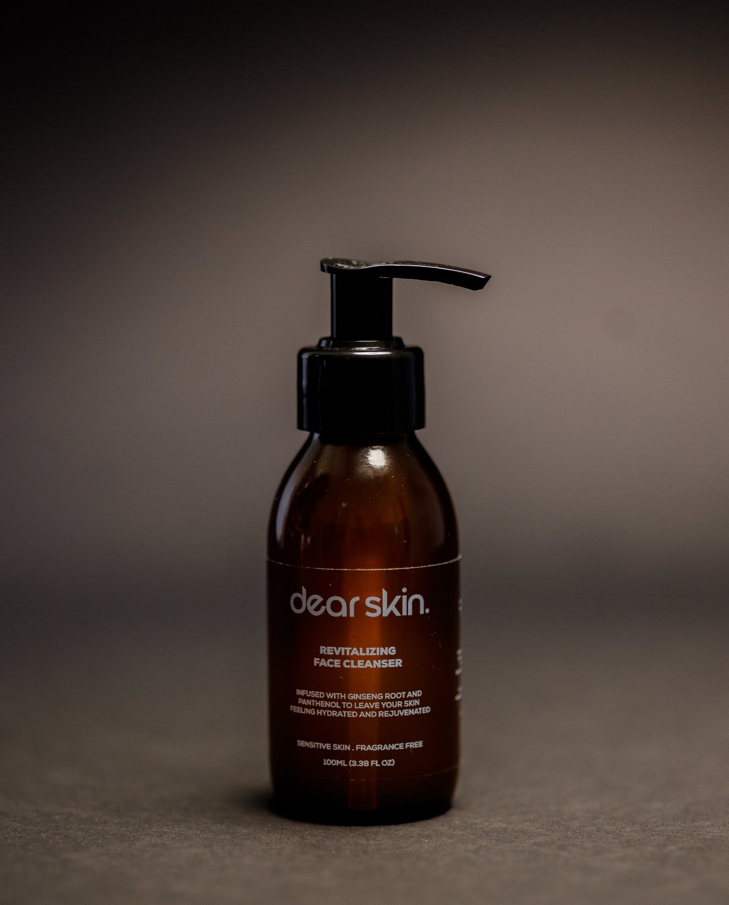Dear Skin Revitalizing Face Cleanser in a 100ml amber bottle, featuring a gentle formula with ginseng root and D-Panthenol for refreshed, balanced skin