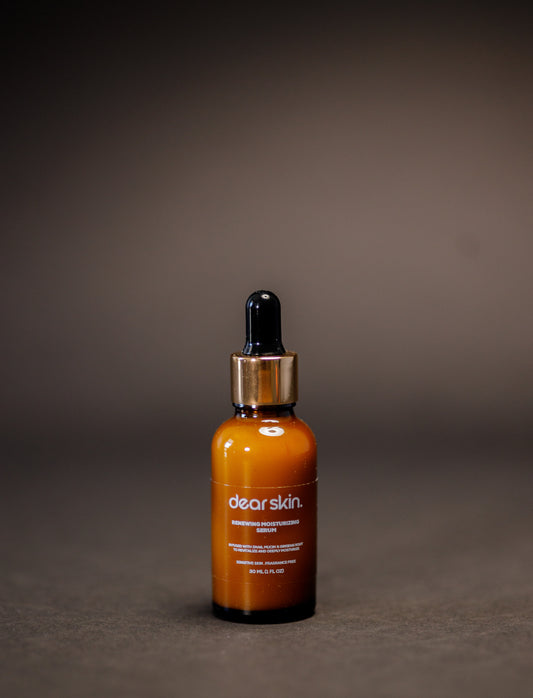 Dear Skin Renewing Moisturizing Serum in a 30ml amber bottle, infused with snail mucin and ginseng root to revitalize and hydrate sensitive skin