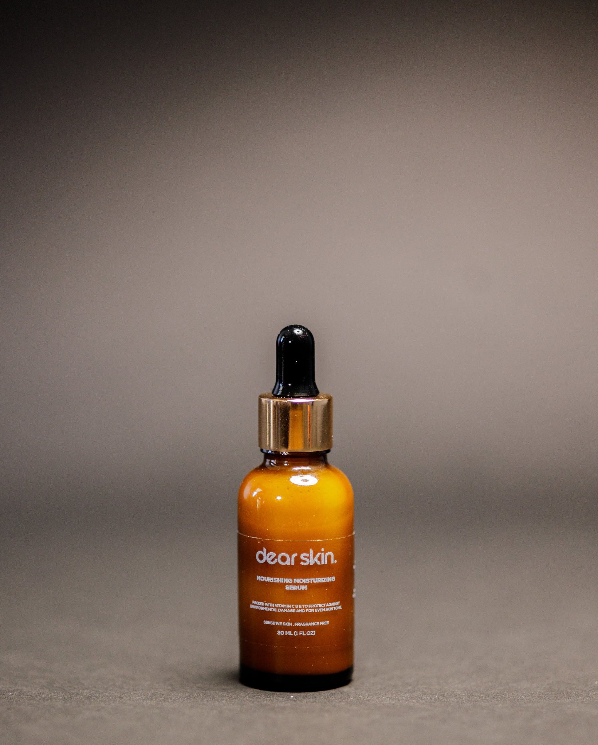Dear Skin Nourishing Moisturizing Serum in a 30ml amber glass bottle, powered by Vitamin C, aloe vera, and baobab oil for radiant, hydrated skin.