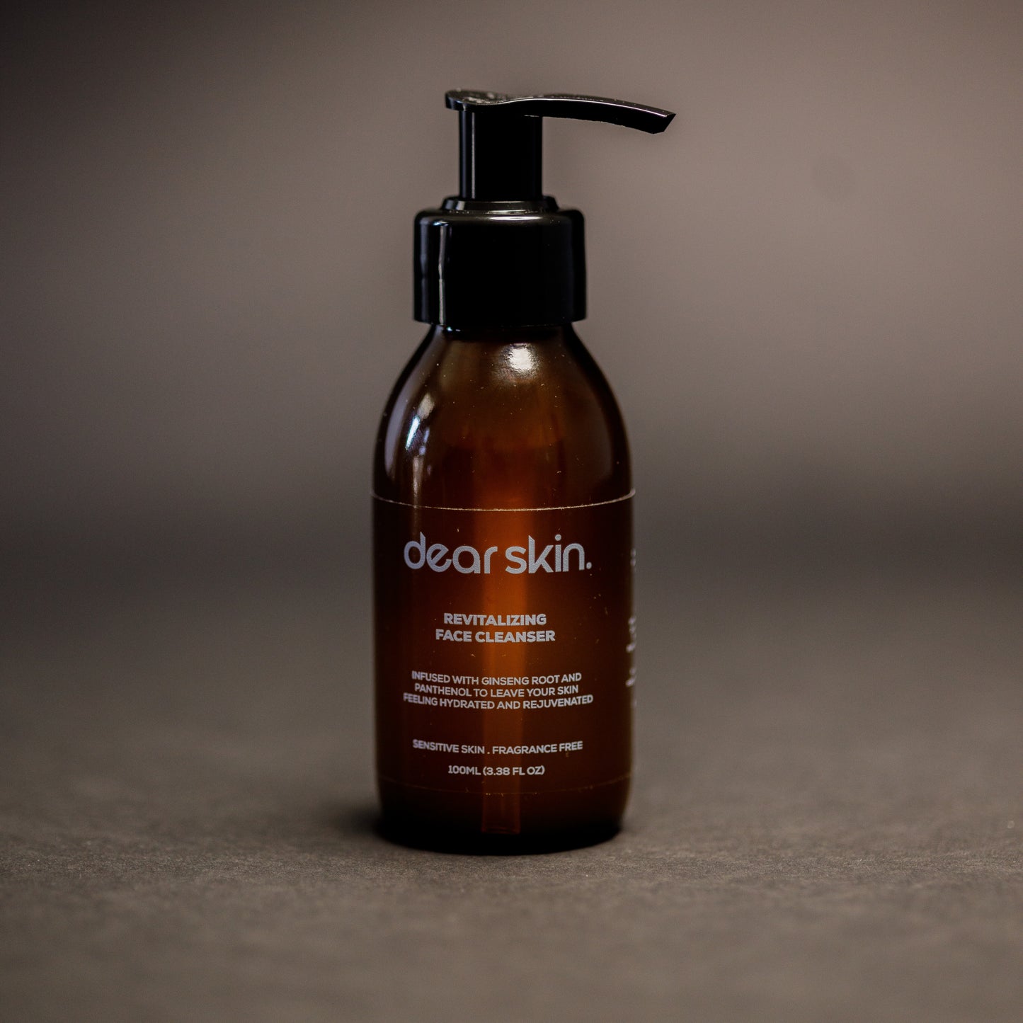 Dear Skin Revitalizing Face Cleanser in a 100ml amber bottle, featuring a gentle formula with ginseng root and D-Panthenol for refreshed, balanced skin