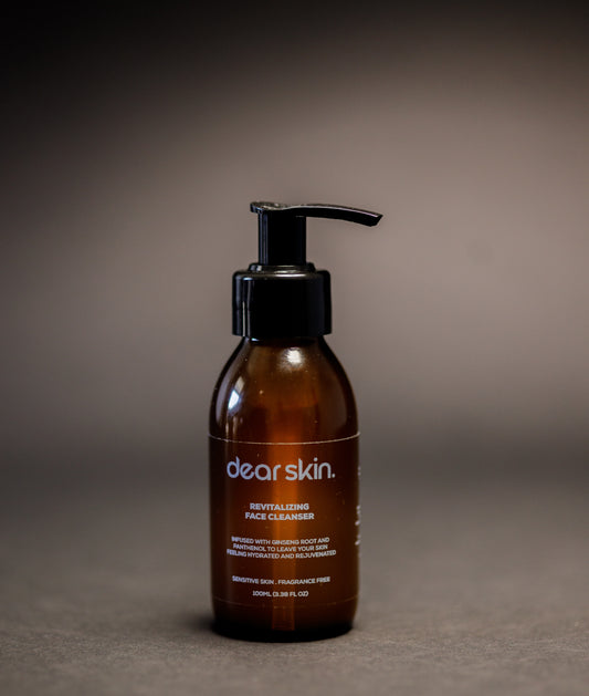 Dear Skin Revitalizing Face Cleanser in a 100ml amber bottle, featuring a gentle formula with ginseng root and D-Panthenol for refreshed, balanced skin