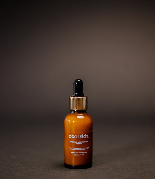 Dear Skin Renewing Moisturizing Serum in a 30ml amber bottle, infused with snail mucin and ginseng root to revitalize and hydrate sensitive skin